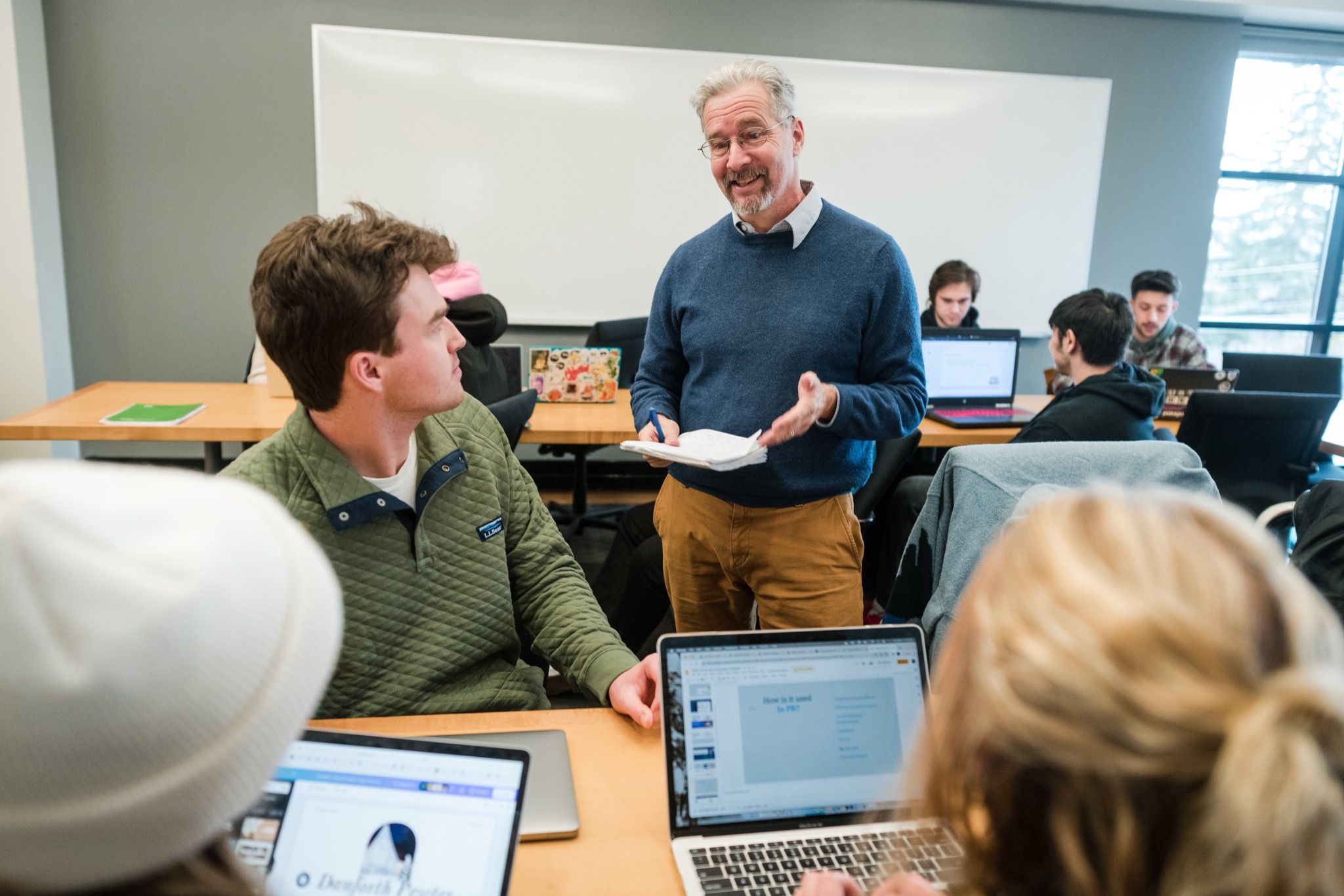 A professor works with students in a Champlain College classroom
